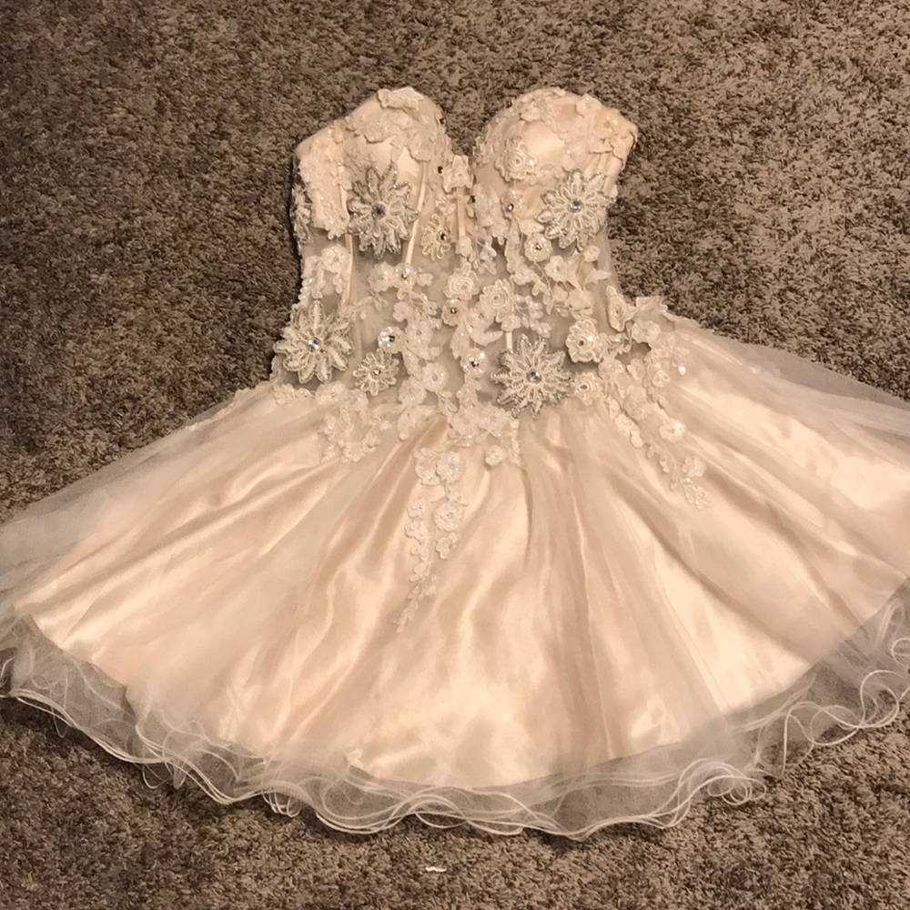 Ivory semi formal dress with detailed beading.
